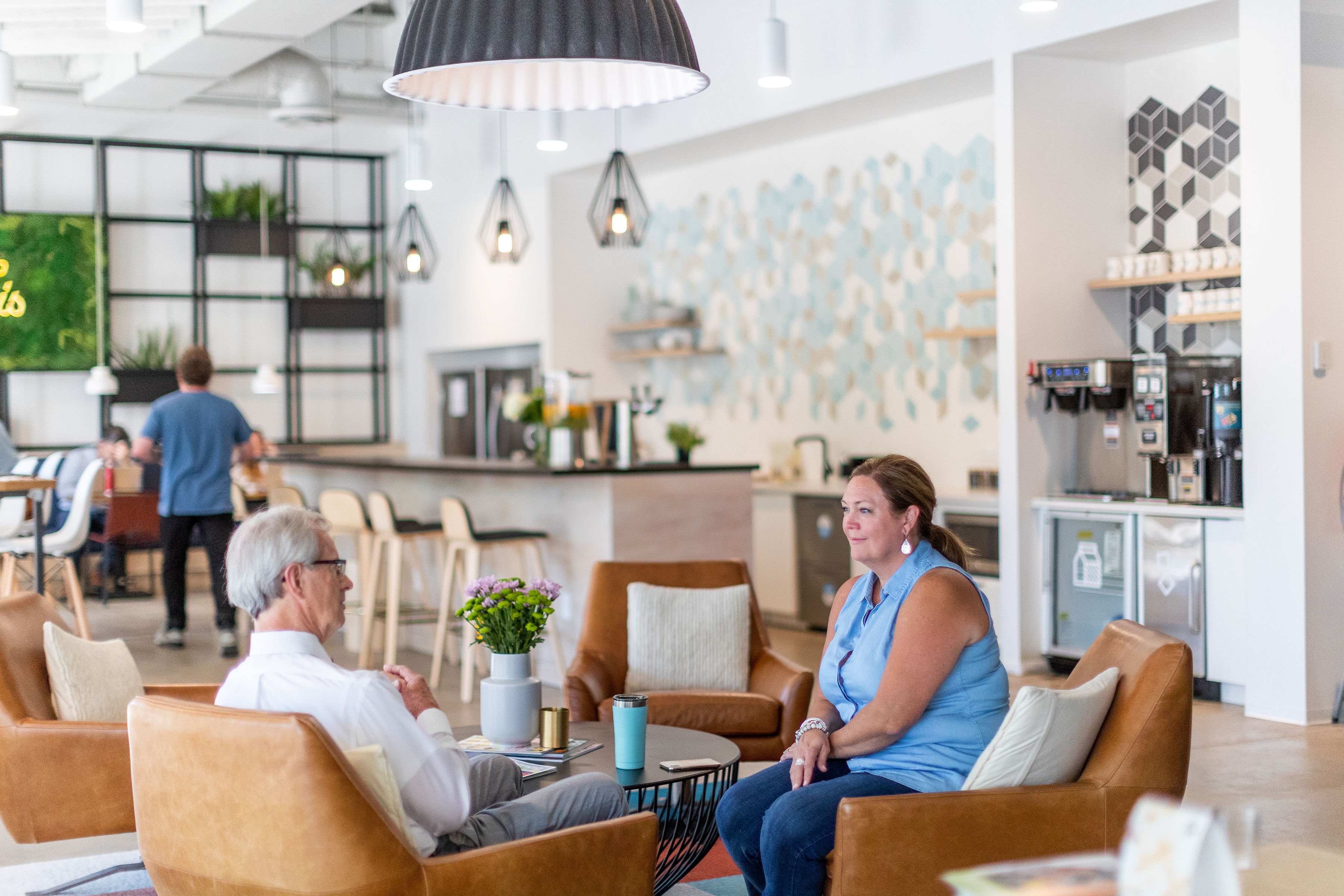 Business owners conversing at a coworking space.